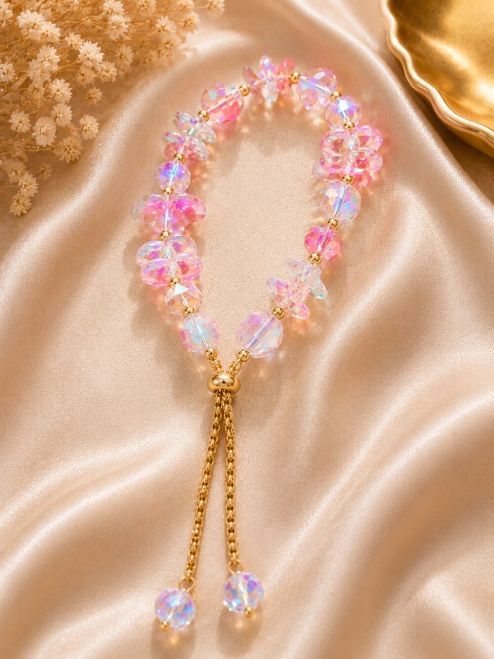 Elegant adjustable bracelet features soft pink and iridescent crystal beads